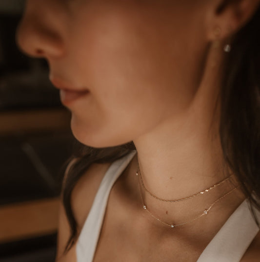 14k gold singapore necklace and 14k gold cable chain with spaced cubic zirconias on a pilates model
